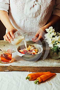 Hands makes strawberry smoothies in wooden table . Fresh strawbe