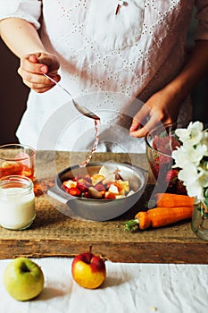 Hands makes strawberry smoothies in wooden table . Fresh strawbe