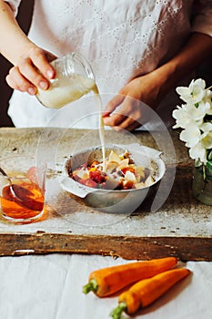 Hands makes strawberry smoothies in wooden table . Fresh strawbe