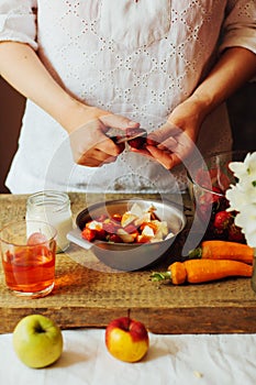 Hands makes strawberry smoothies in wooden table . Fresh strawbe