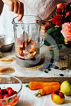 Hands makes strawberry smoothies in wooden table . Fresh strawberry smoothies fruit. Recipe carrot-strawberry smoothie. Action. R