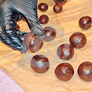 Hands making chocolate treats