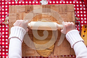 Hands making from dough Christmas gingerbread man