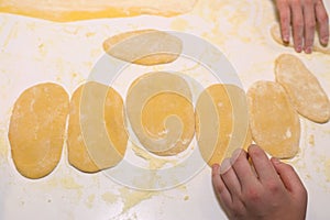 Hands making dough preparing for pasta cooking close up photo