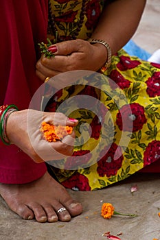 Hands making garlands, Kathmandu, Nepal