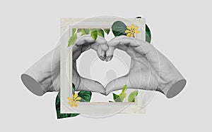 Hands making Heart symbol, with retro picture frame and tropical leaves and flower