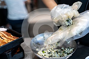 Hands making Korean seaweed rice ball called in Korean is Jumeogbab, jumeokbap, Onigiri or Chu Mok Bab is famous traditional photo