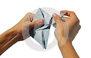 Hands making origami