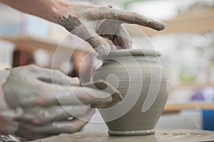 Hands Making Pottery On A Wheel