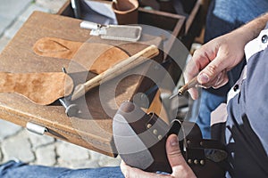 Hands making shoes