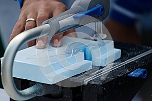 Hands of a male carpenter making a workpiece on a joiner`s machine