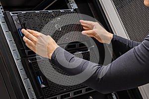 Hands Of Male Technician Installing Servers In Datacenter