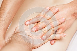 Hands of male therapist doing back massage