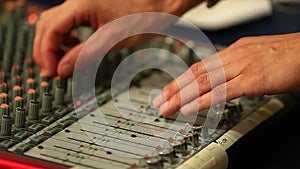 Hands of man adjusting sound mixer