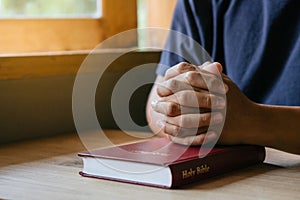 Hands of man with Bible praying.Christian life prayer to god. Man Pray for god.