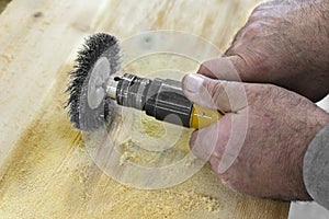 Hands man with electrical rotating brush metal disk sanding piec