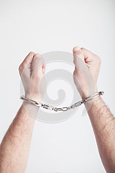 Hands of a man with handcuffs