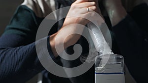 Hands of a man holding an inhaler, close-up. Colds, illness, flu, treatment