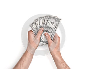 Hands of man holding one-dollar bills on white background.