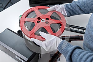 Hands man holding reel 16mm film