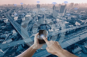 Hands man holding smartphone and blue city with wifi network