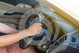 Hands man holding steering wheel and on automatic gear shift