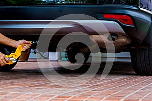 Hands of man holding yellow car towing strap with car