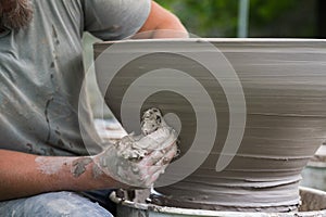 Hands of a man making a clay vase