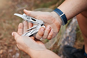 Hands, man or multi purpose knife in environment camping land, sustainability forest woods or hiking mountains. Zoom