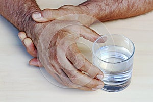 The hands of a man with Parkinson`s disease tremble