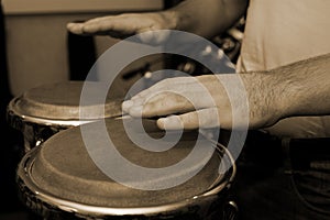 Hands of man playing the bongos photo