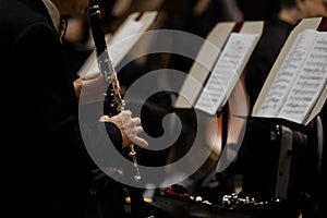 Hands of man playing the clarinet in the orchestra