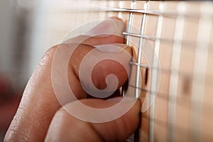 Hands of man playing electric guitar