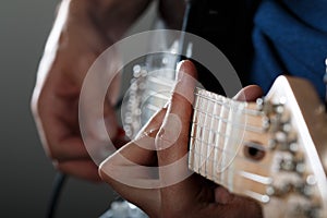 Hands of man playing electric guitar