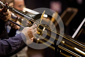 Hands of man playing the trombone