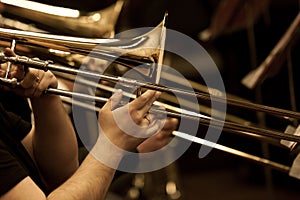 Hands of man playing the trombone