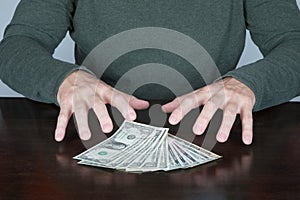 Hands of man ready to catch a bundle of dollars