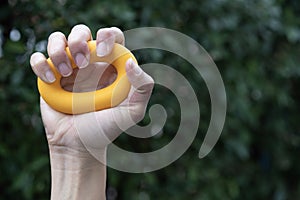 Hands of a man squeezing a green stress ball