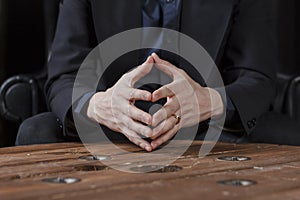 hands of a man in a suit, close-up.