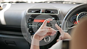 Hands of man using clear tablet in a car for transport futuristic and technology concept