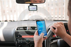 Hands of man using mobile smart phone vehicle analysis appiication in the car for mobile technology application concept