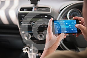 Hands of man using mobile smart phone vehicle analysis appiication in the car for mobile technology application concept