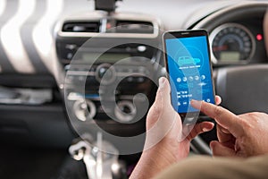 Hands of man using mobile smart phone vehicle analysis appiication in the car for mobile technology application concept