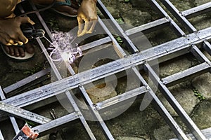 Hands of man welding steel structure