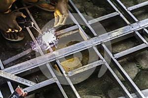 Hands of man welding steel structure