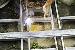 Hands of man welding steel structure