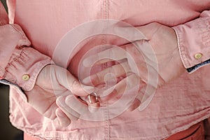 Hands of a man who took off a golden, wedding ring behind back, having come to his mistress.