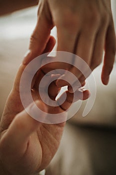 Hands of a man and a woman against the background of a blurred window. The gentle touch of a man and a woman. Love connection help