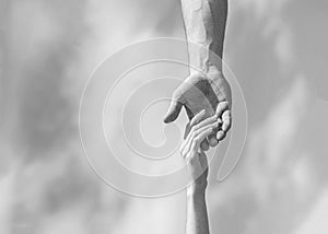 Hands of man and woman on blue sky background. Lending a helping hand. Hands of man and woman reaching to each other