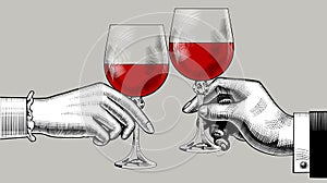 Hands of man and woman clink glasses with red wine photo